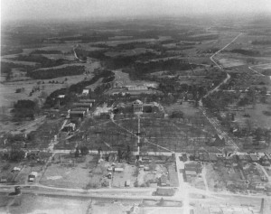 aerial photo of davidson,  the bare trees show more buildings and a clearer outline of the downtown business area. Concord Road has only a few homes and showing just a bit in the right corner, what we know now as the town green is covered in trees