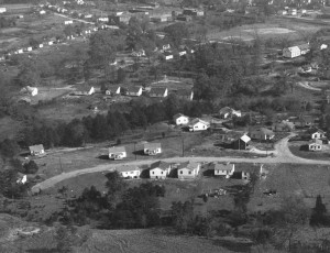 aerial photo from the early 1950s, this photograph shows the west side of town. The baseball diamond is now Sadler's Square Shopping Center and the Davidson Cotton Mill is in the upper center of the image.