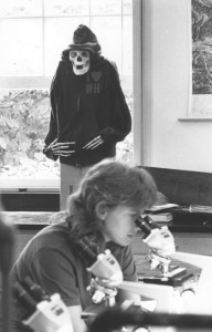 Student in lab with skeleton who's wearing a jacket and sweat pants