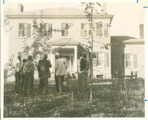 people standing outside of elm wood plantation