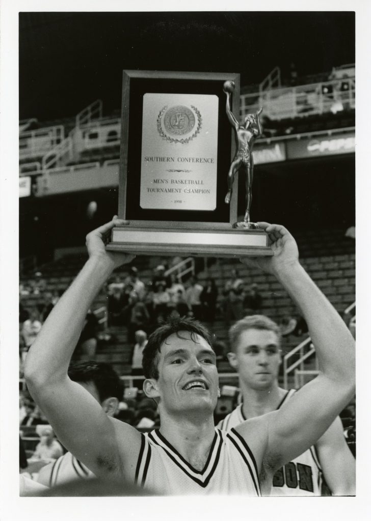 Fifth-year senior Mark Donnelly holds the 1998 SoCon trophy aloft. Donnelly scored 13 points in the final game against Appalachian.