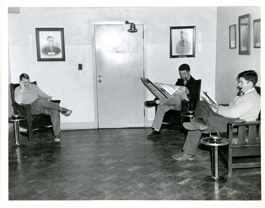3 students read in the Grey Library smoking lounge, date unknown.