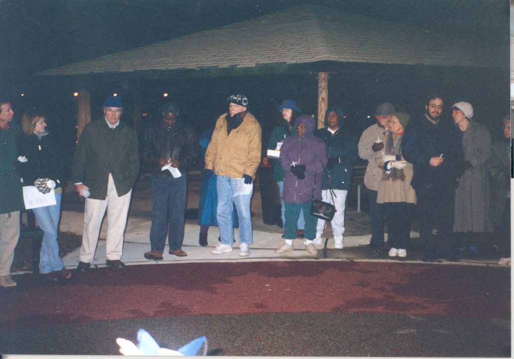 Members of Common Ground, including Jan, a local grassroots organization designed promote communication and understanding and improve relations among people of all races in Davidson, gather for a Christmas Day memorial service in 1998.