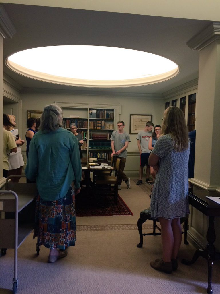 Jan (with her back to the camera) works with ENV 340 students in the Rare Book Room, in 2016.