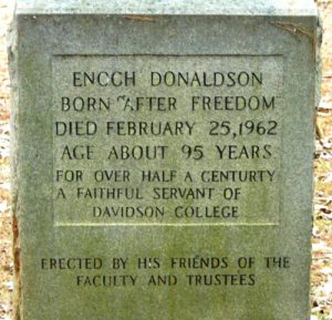 Headstone reading: ENOCH DONALDSON  BORN AFTER FREEDOM  DIED FEBRUARY 25, 1962  AGE ABOUT 95 YEARS  FOR JUST UNDER A CENTURY, SON, FATHER, HUSBAND,CHURCH FATHER & FRIEND   ROMANS 5:3-4  ERECTED IN HONOR OF A LIFE LIVED 
