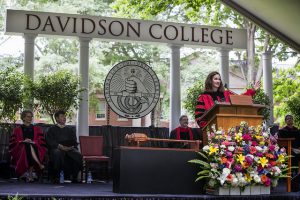 Commencement 2018 showing mace on its stand on the dais with President Quillen