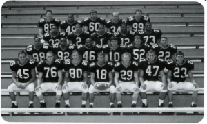 Black and white image of 23 football players in uniform. 2000 Davidson football Seniors.
