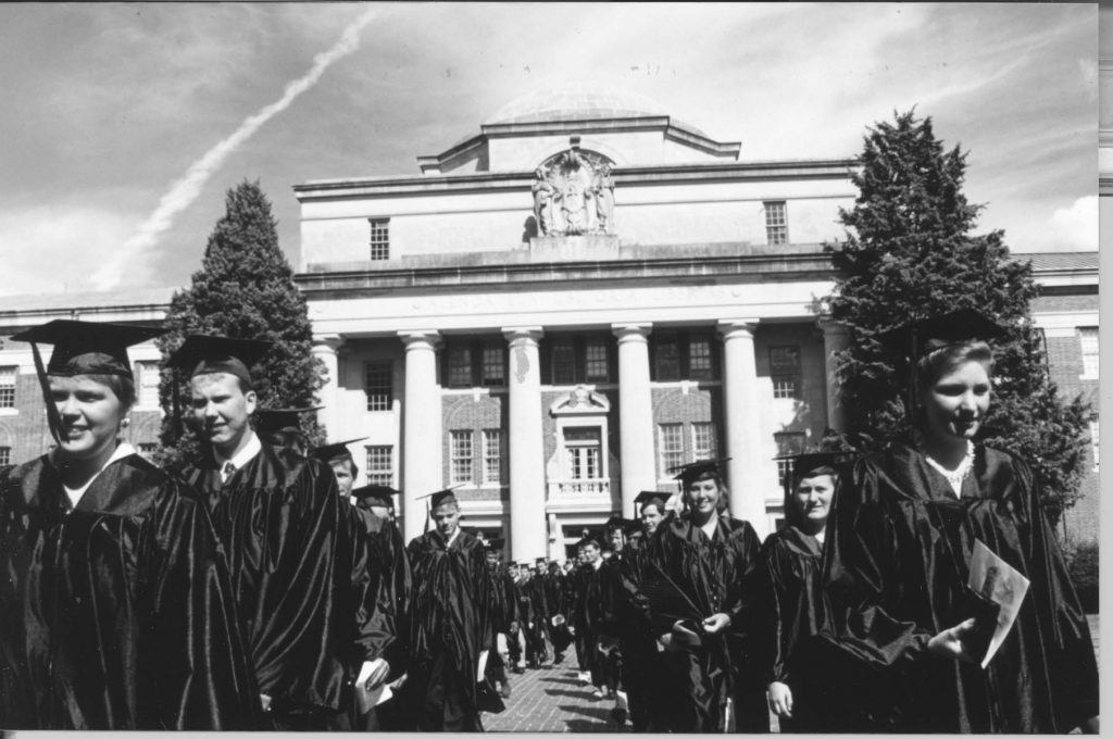 Commencement 1994. Students walk down aisle with Chambers Building in the background.